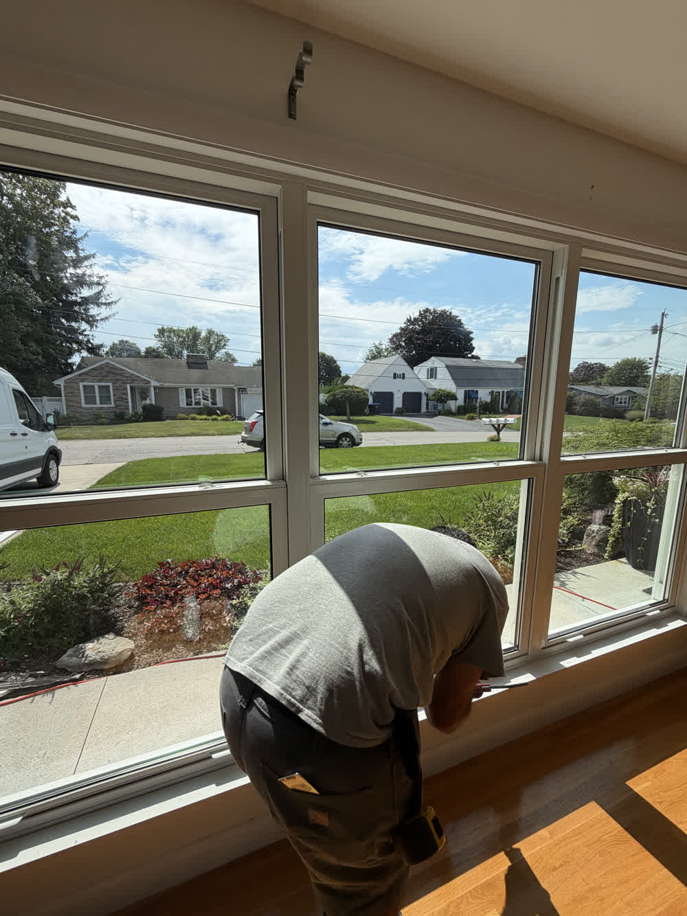 Adjusting a large window unit from inside the home